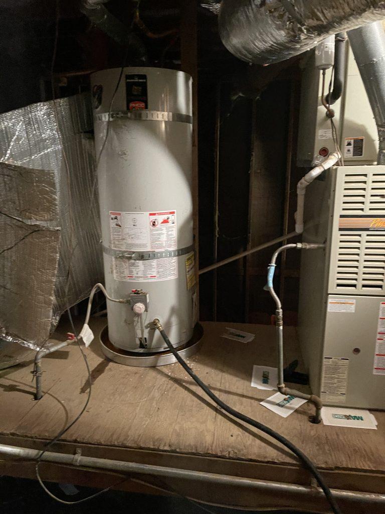 Image depicting a skilled professional installing a new hot water heater, highlighting the cost-effective and reliable replacement services offered in East Palo Alto
