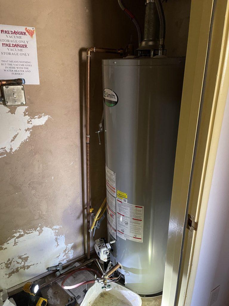 Close-up image of a water heater under repair in a Milpitas residence, demonstrating our excellent service standards
