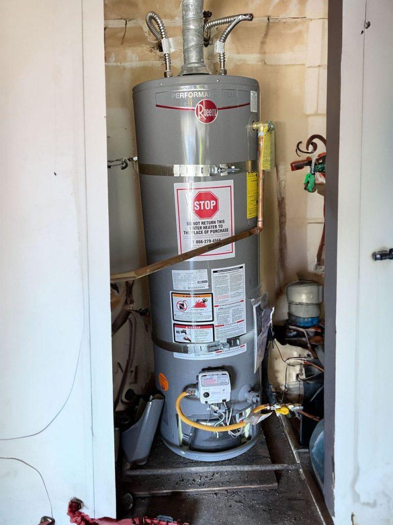 Specialist from United Plumbing fitting a cost-effective water heater in a Los Altos Hills home