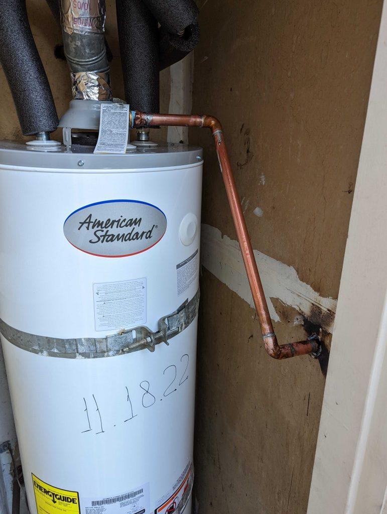 A plumber inspecting a water heater in Millbrae | United Plumbing