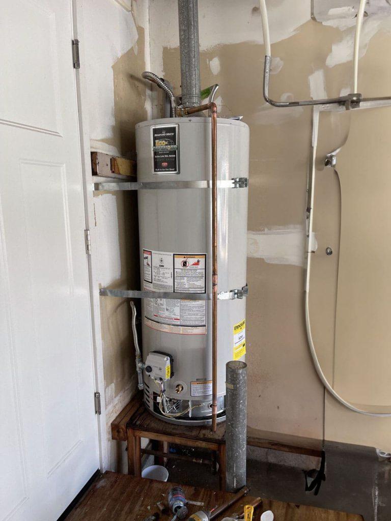 Expert from United Plumbing installing an affordable water heater in a Milpitas home
