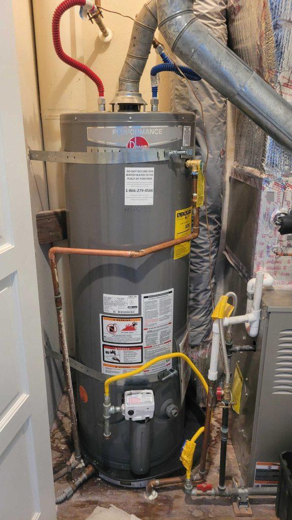 A professional plumber installing a 50 gallon water heater in San Carlos | United Plumbing