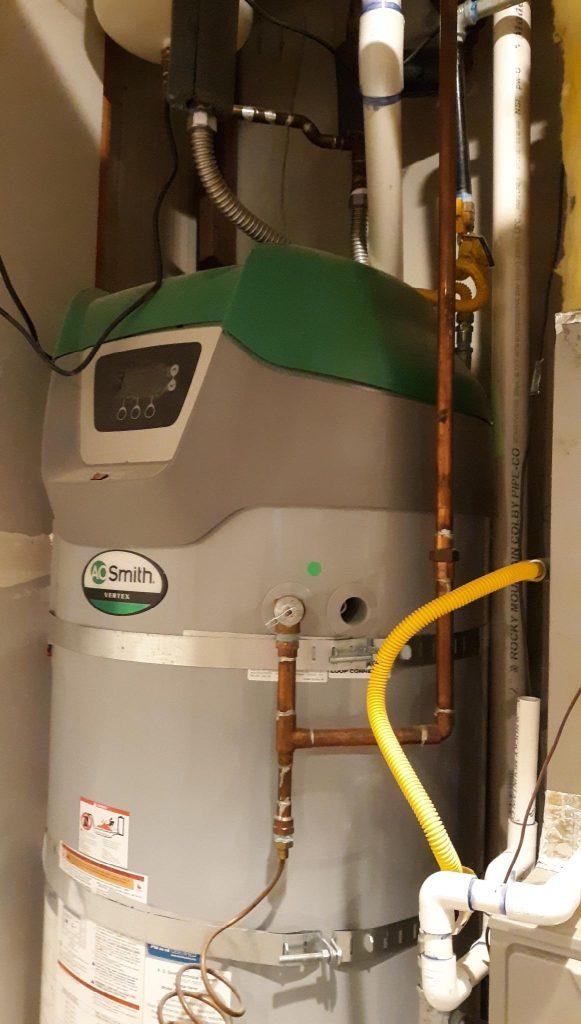 A plumber examining a water heater in San Mateo