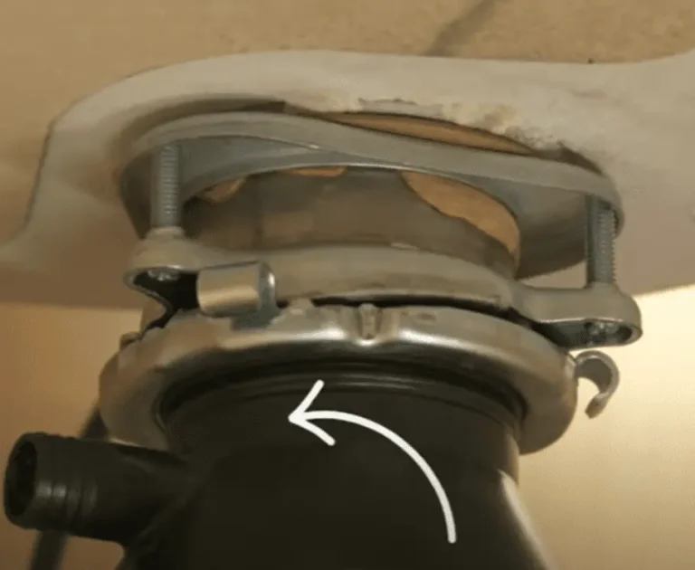 Unscrew the disposal from the mounting bracket