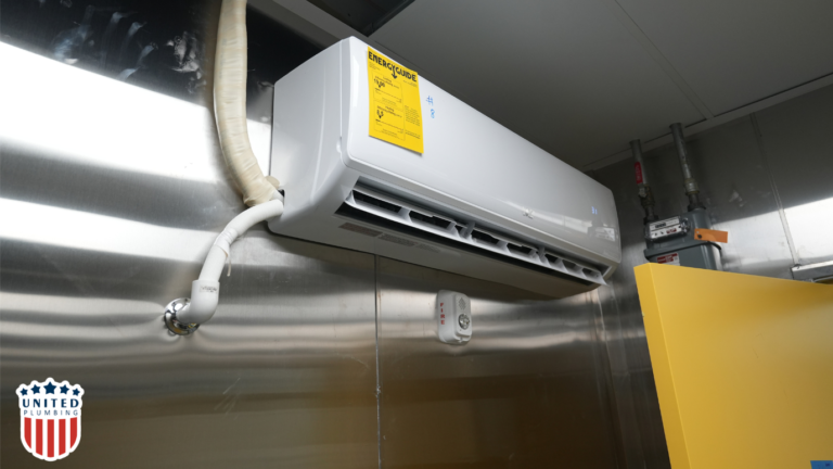 Wall-mounted ductless mini-split AC unit with visible energy guide label and piping connection.