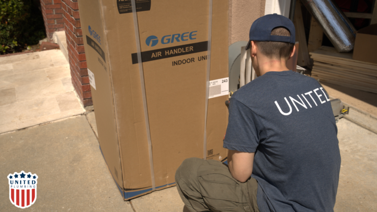 United Plumbing technician preparing for installing a subpanel and electrical system upgrade near an indoor air handler unit.