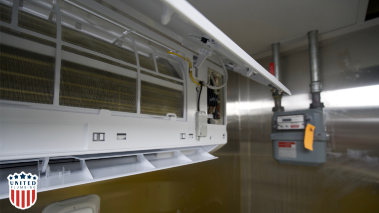 Close-up view of the internal components of a wall-mounted air conditioning system, with exposed wiring and filters.