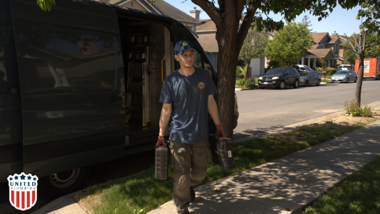 United Plumbing technician carrying tools to a home for installing a subpanel and completing electrical panel upgrades.