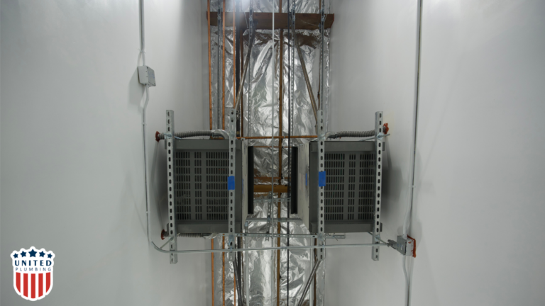 Two HVAC units mounted on a ceiling support system, part of a commercial air conditioning installed by United HVAC electrical & plumbing. 