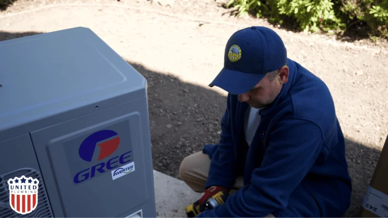 Professional HVAC installer setting up a GREE inverter heat pump system outdoors