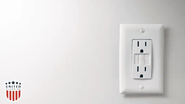 Close-up of a GFCI electrical outlet on a white wall, promoting home electrical safety.
