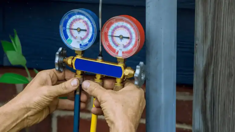 Technician using AC gauges to diagnose refrigerant leak in air conditioner not cooling.
