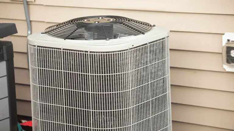 Blocked AC condenser unit outside home affecting central air not cooling properly.