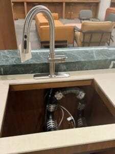Kitchen faucet installation with exposed plumbing connections