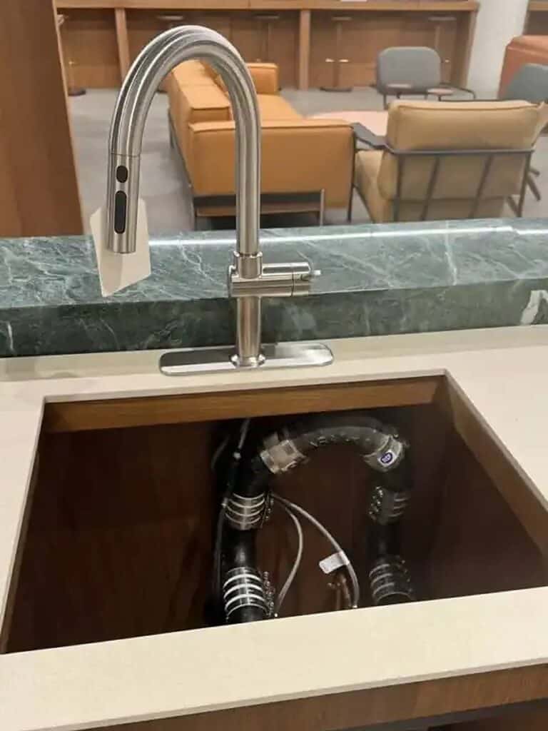 Kitchen faucet installation with exposed plumbing connections