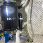 Moen garbage disposal installed under a kitchen sink